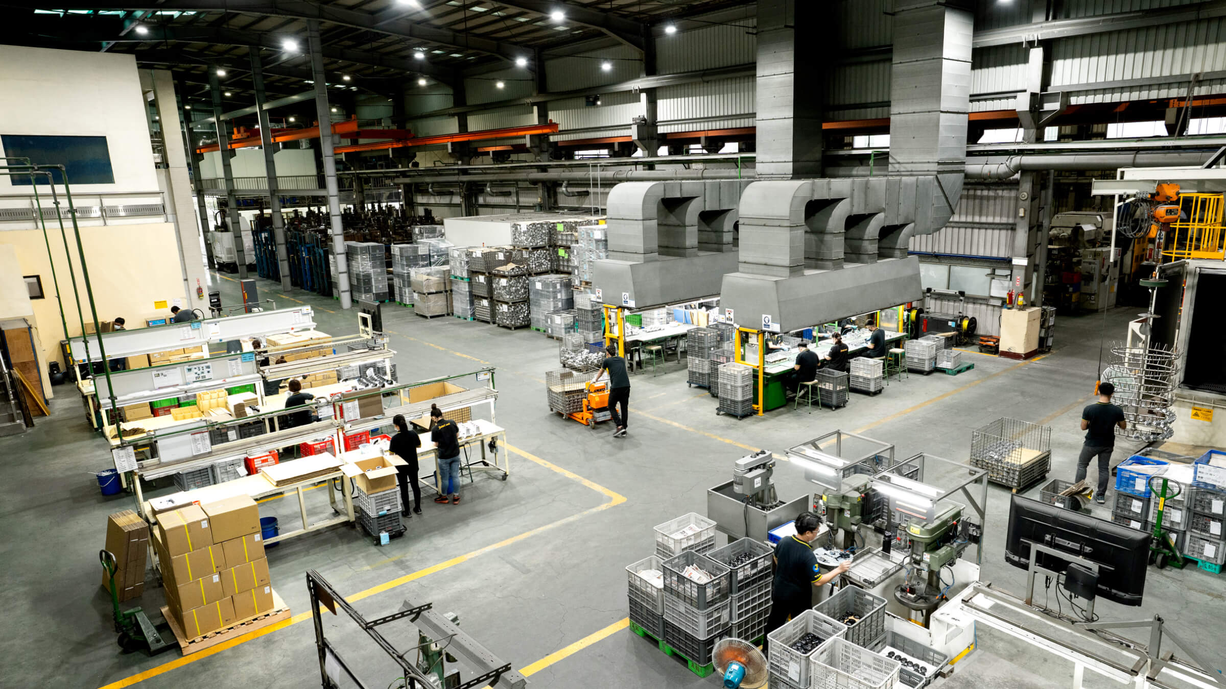 Automated vertical shot blasting system at JoinCast's Taiwan facility, processing a high-volume batch of aluminum die castings to create a uniform, matte surface finish.