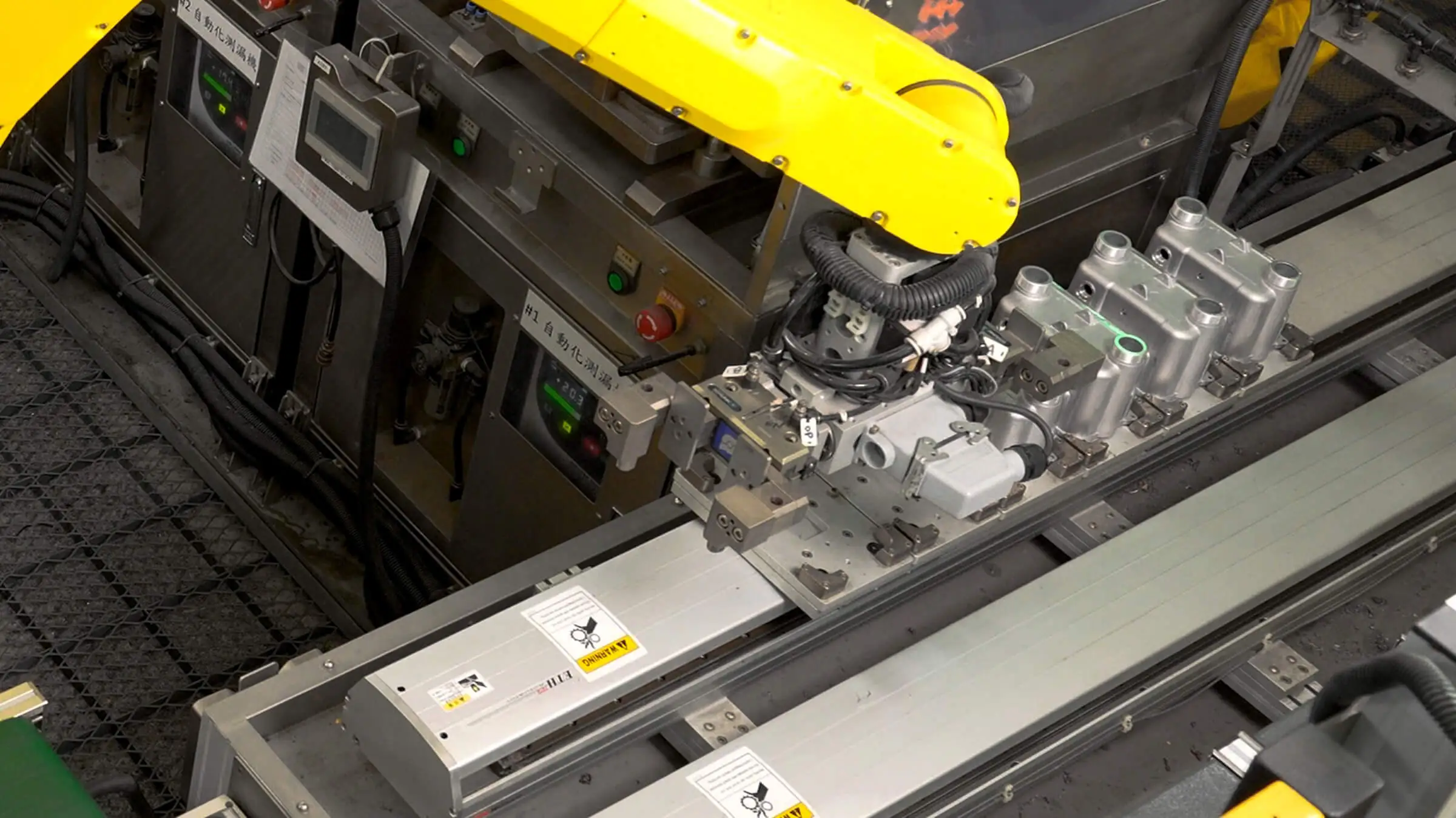Integrated FANUC robotic arm performing automated material handling and real-line quality monitoring for aluminum die castings.