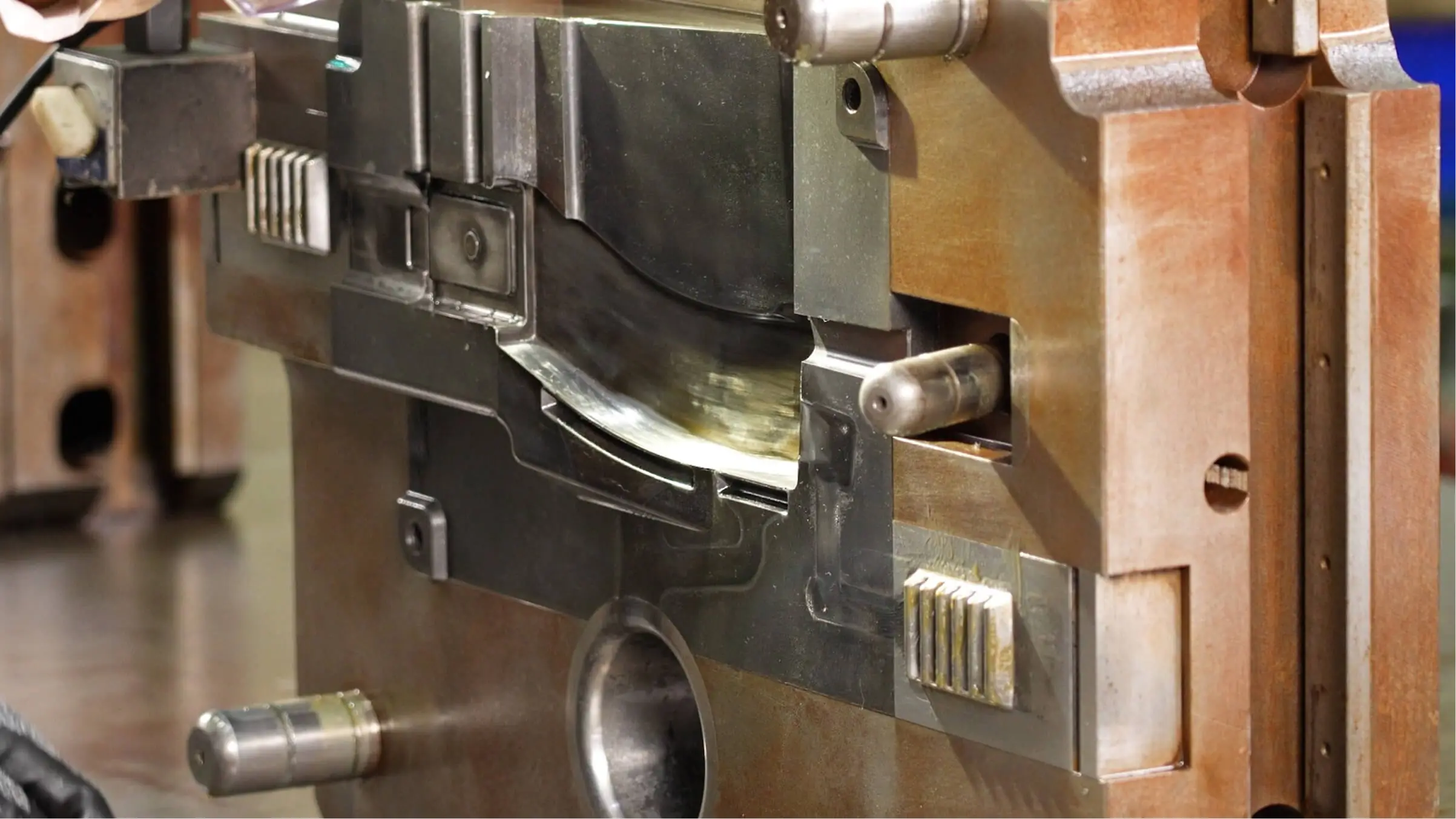 Expert JoinCast technician performing precision maintenance and manual adjustment on a high-pressure aluminum die casting mold.