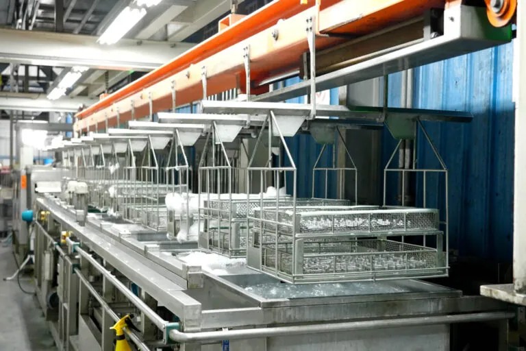 Fully automated surface treatment line at JoinCast’s Taiwan facility providing consistent chemical immersion and coating for aluminum die cast components.